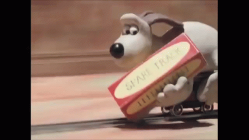 A Gif From Wallace and Gromit about the Dog laying down train tracks as he is riding the train